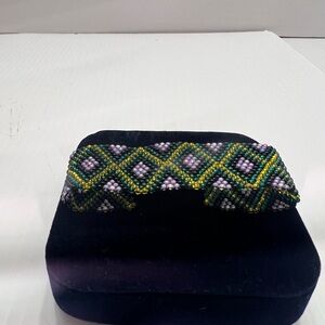 Handcrafted Beaded Bracelet with Green and Purple Design